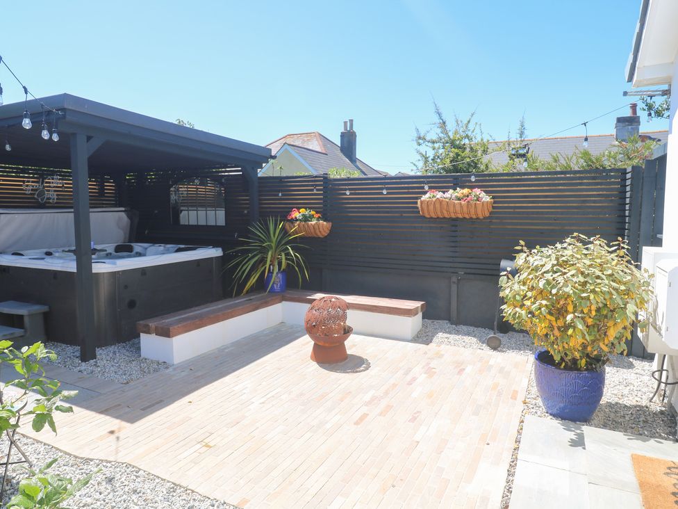 An outdoor area with a hot tub and seating at Carn Brea in Redruth