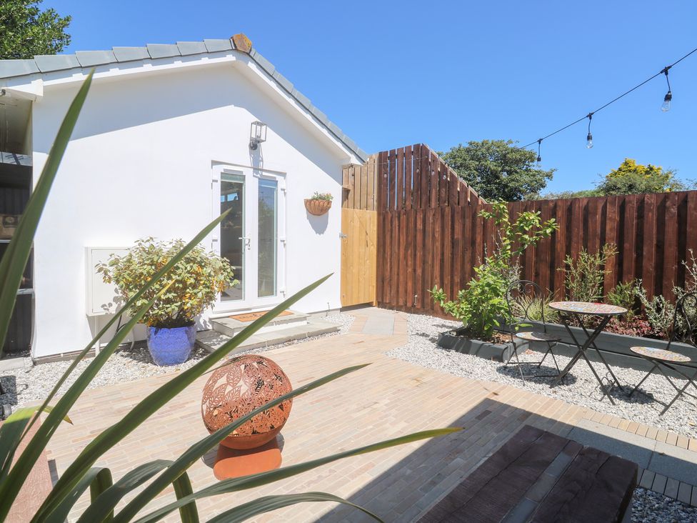 An outdoor area with plants and tables at Carn Brea in Redruth
