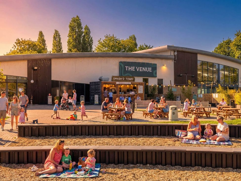 An outdoor seating area with people at The Venue in Billing Aquadrome Holiday Park