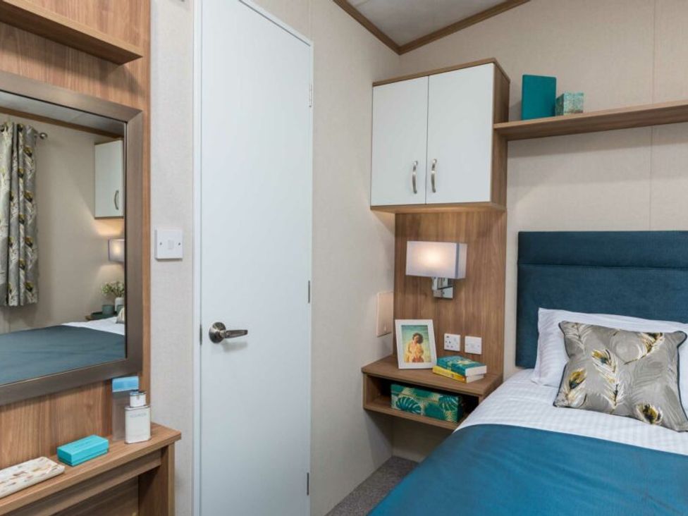 A bedroom with bed and mirror at Aquadrome Abode 3bed - Billing Aquadrome