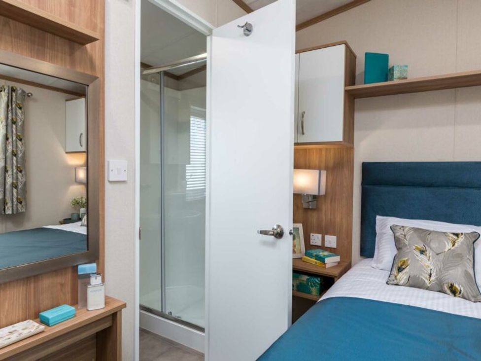 A bedroom with a bed and shower room at Aquadrome Abode 3bed - Billing Aquadrome