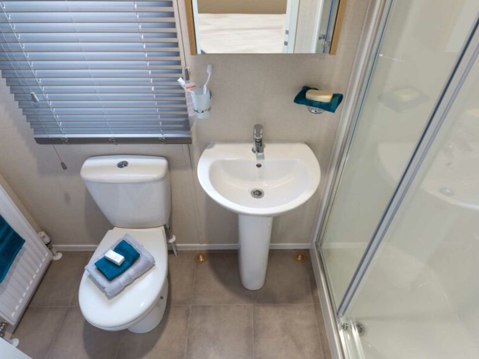 A bathroom with a sink, toilet, and shower at Aquadrome Abode 3bed - Billing Aquadrome