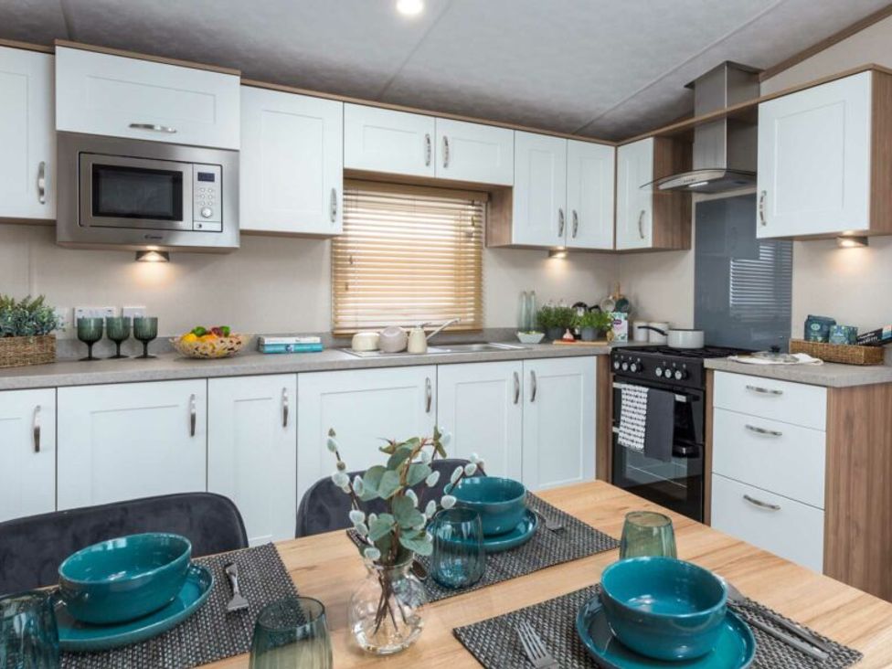 A kitchen with cabinets and appliances at Aquadrome Abode 3bed - Billing Aquadrome