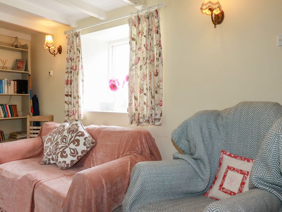 A living room with a sofa and armchair at Trevean in Bude