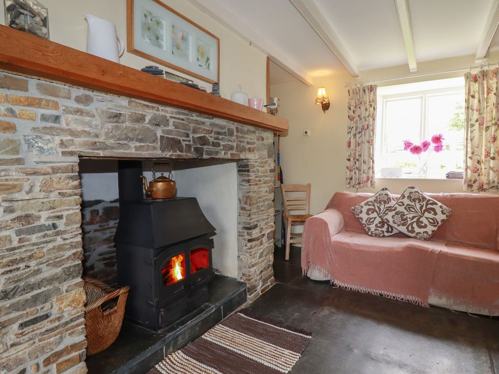 A living room with a fireplace and couch at Trevean in Bude