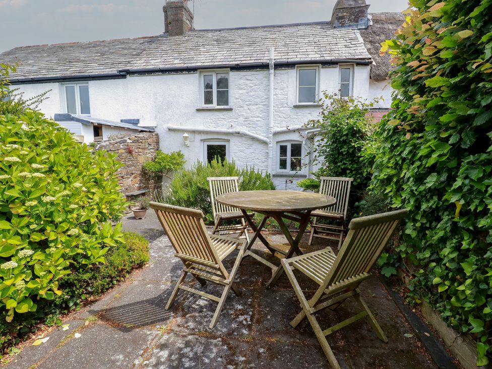A garden with a table and chairs at Trevean in Bude