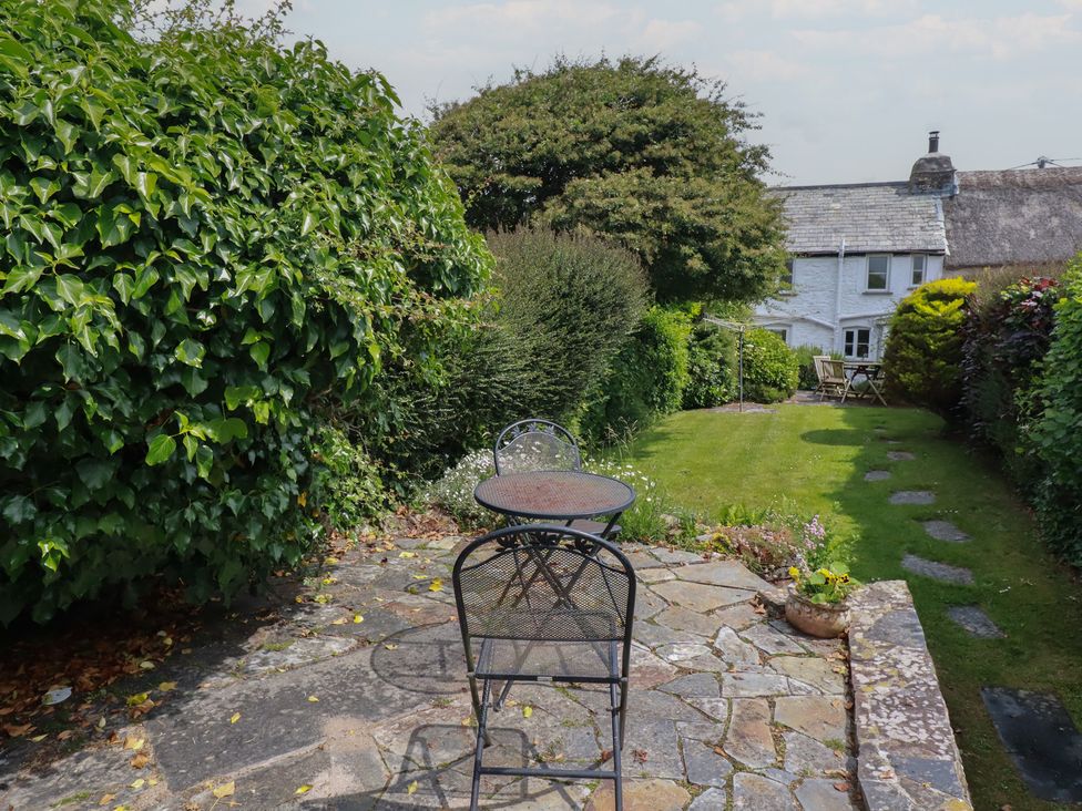 A garden with a table and chairs at Trevean in Bude
