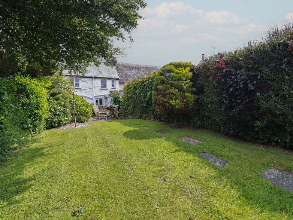 A garden with a clothesline and seating at Trevean in Bude