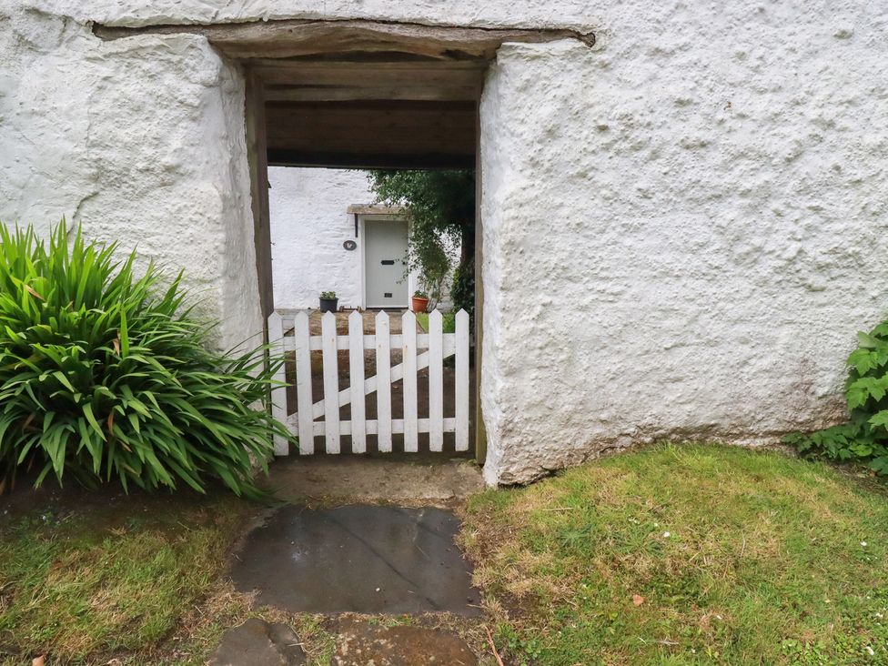 A view of a white gate and door at Trevean in Bude