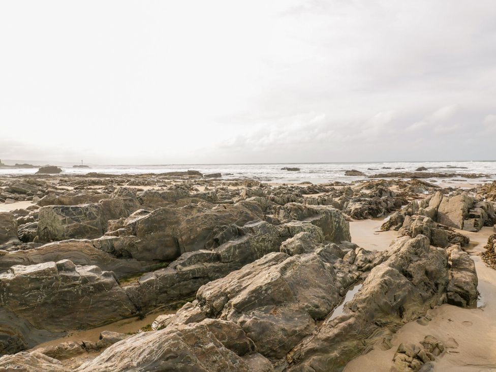 A beach with rocks and ocean waves at Trevean in Crackington Haven