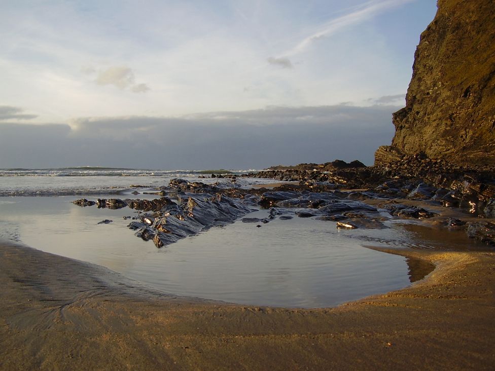 A beach with rocks and water at Trevean in Crackington Haven