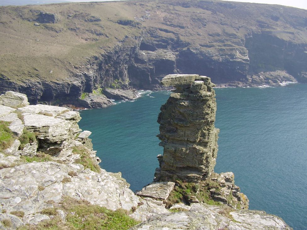 A cliff with a rock formation overlooking the sea at Trevean in Crackington Haven