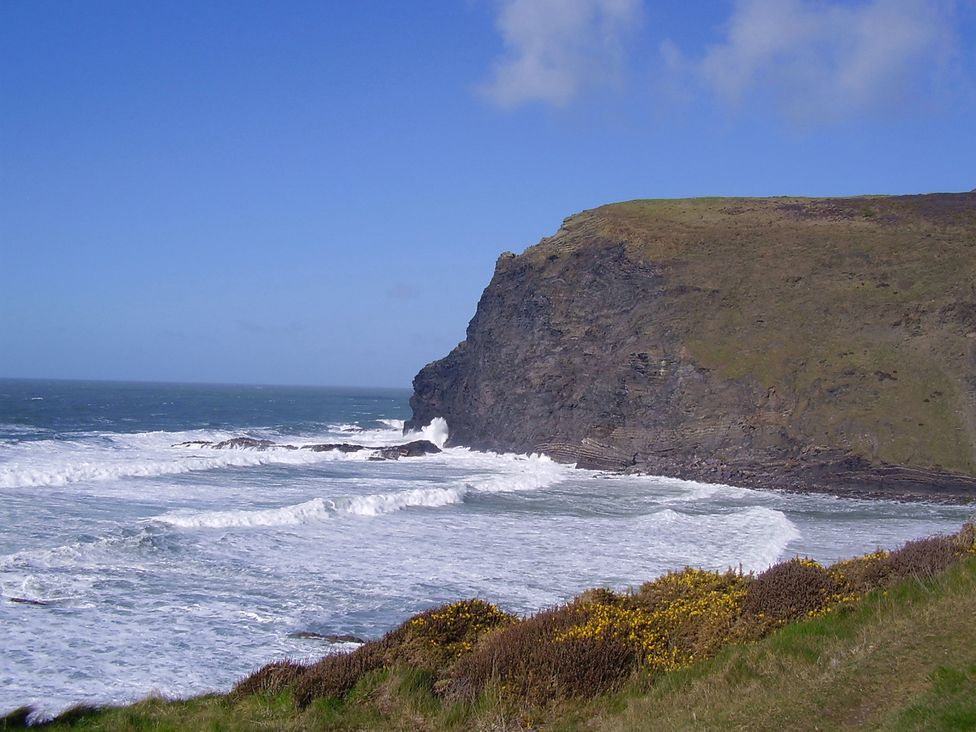 A coastal view with cliffs and waves at Trevean in Crackington Haven