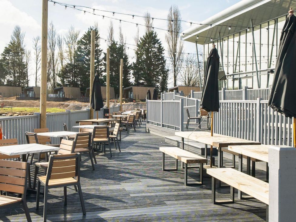 An outdoor patio with tables and chairs at Skylight Stargazer - Billing Aquadrome