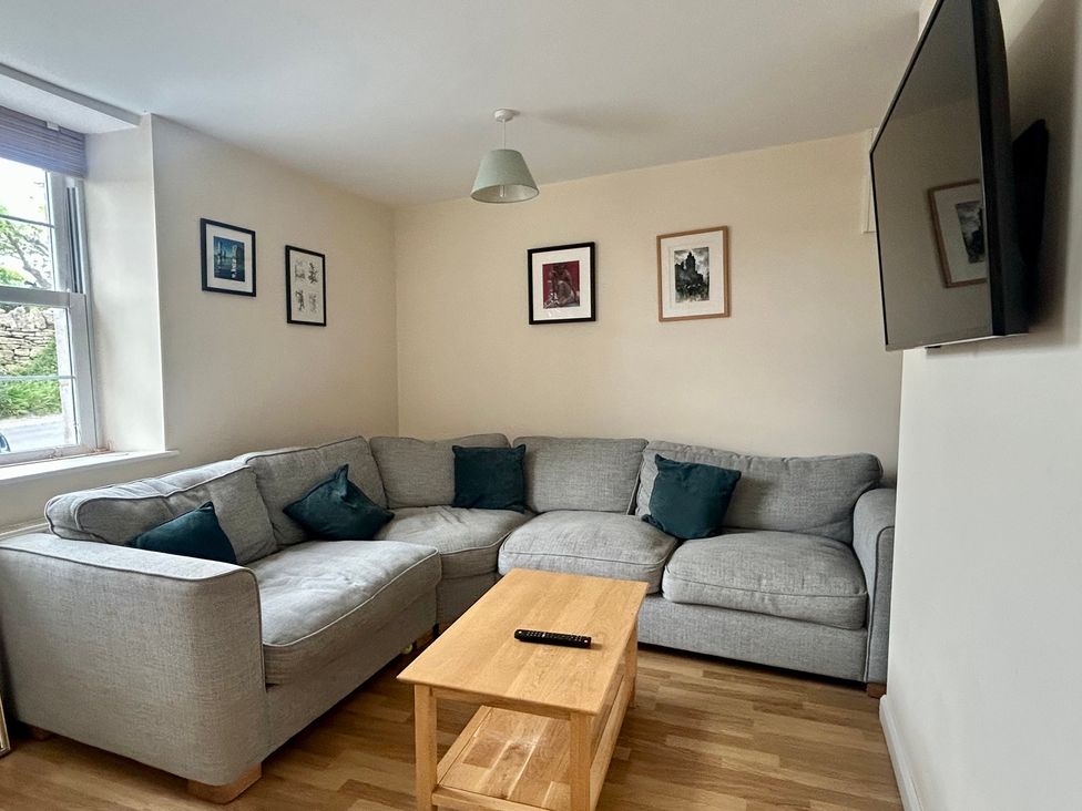 A living room with a sofa and coffee table at Mallow Cottage in Langton Matravers