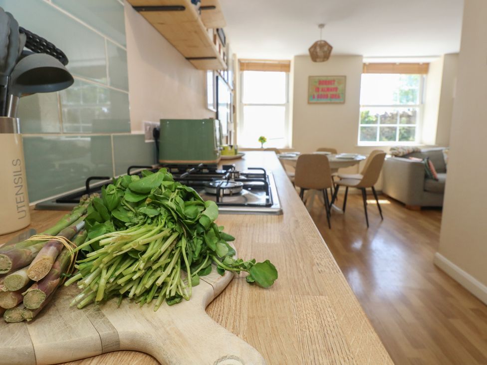A kitchen with utensils and vegetables at Mallow Cottage in Langton Matravers
