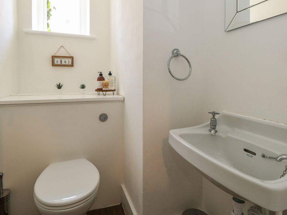 A bathroom with a toilet and sink at Mallow Cottage in Langton Matravers