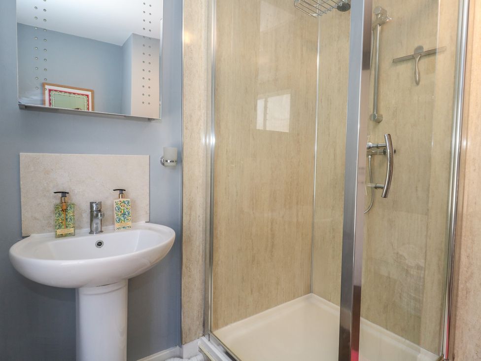 A bathroom with a shower and sink at Mallow Cottage in Langton Matravers