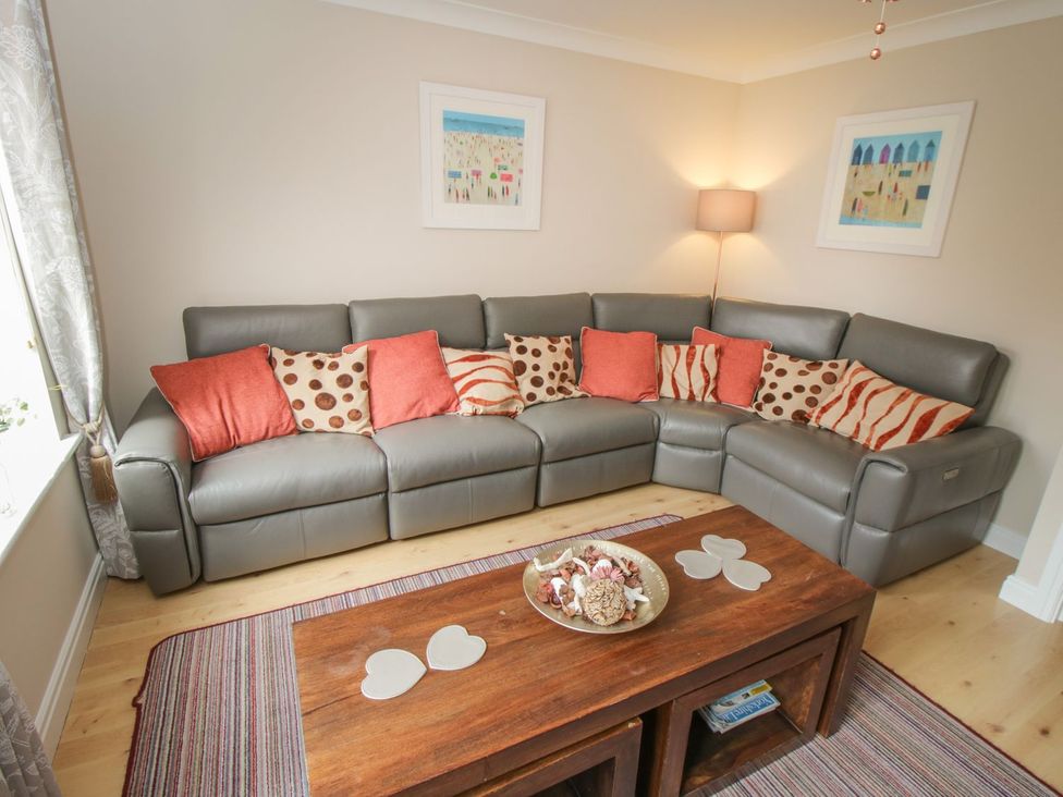 A living room with a corner sofa and a coffee table at The Shipwrights in Whitby