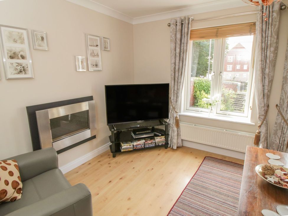 A living room with a sofa and television at The Shipwrights in Whitby