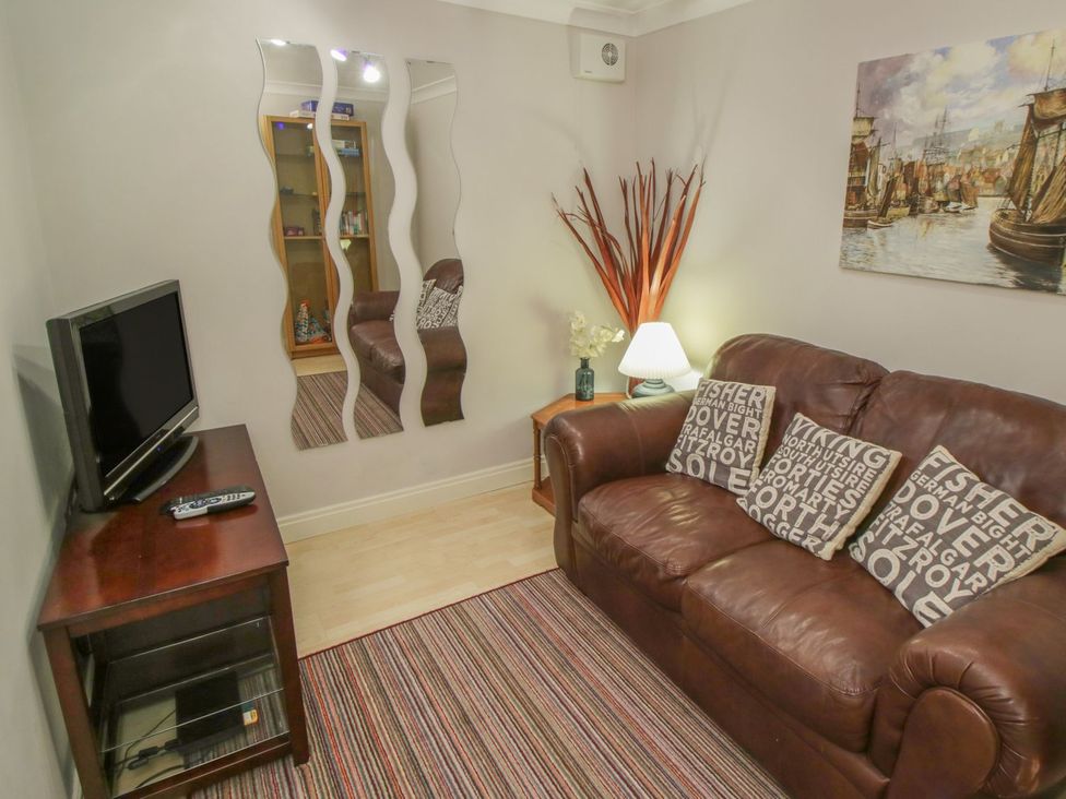 A living room with a sofa and television at The Shipwrights in Whitby