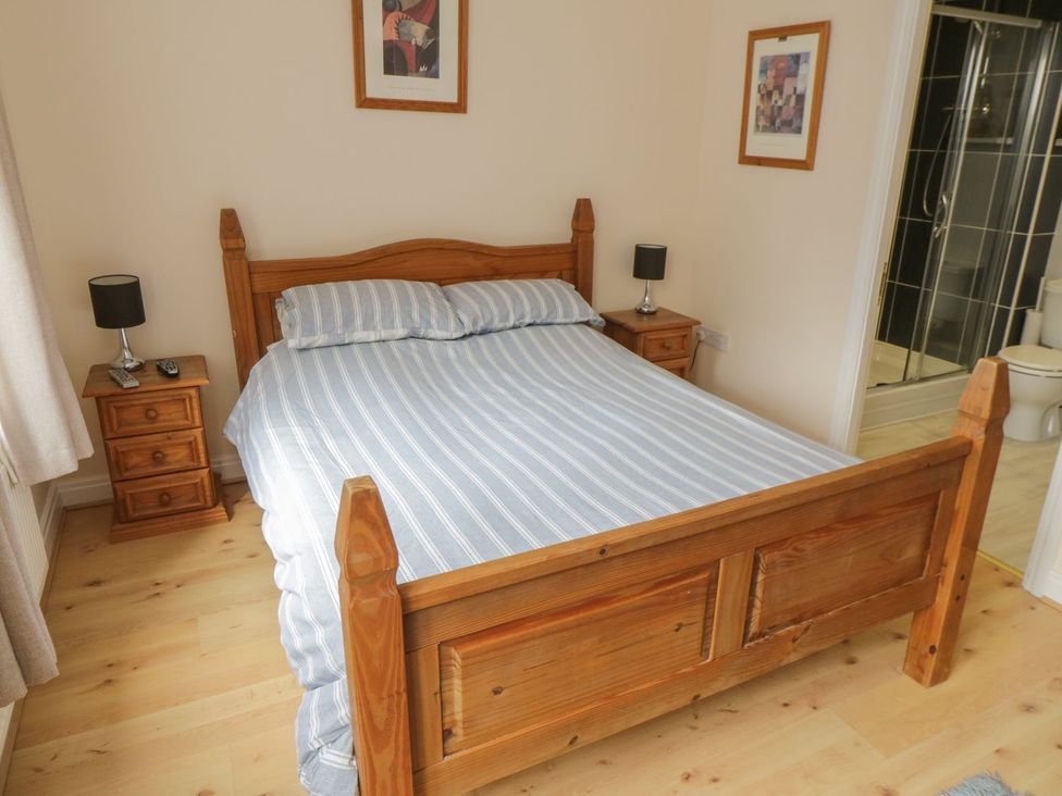 A bedroom with a bed and bedside table at The Shipwrights in Whitby