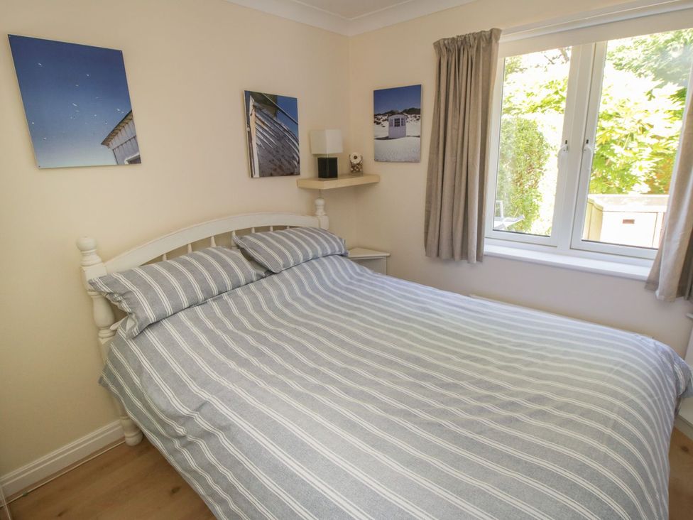 A bedroom with a bed and wall art at The Shipwrights in Whitby