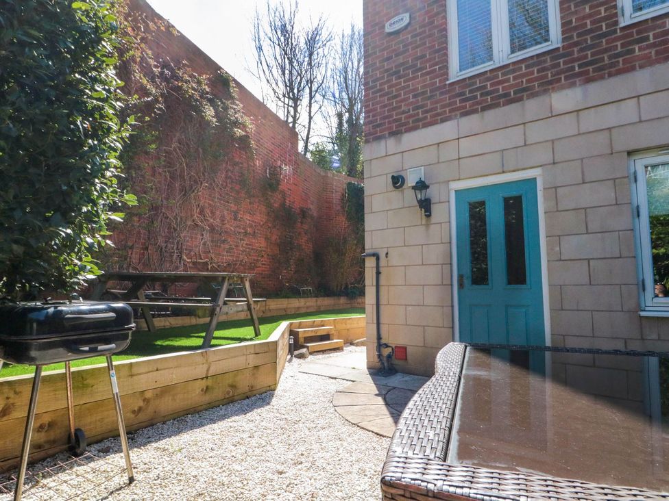 A garden with a barbecue and table at The Shipwrights in Whitby