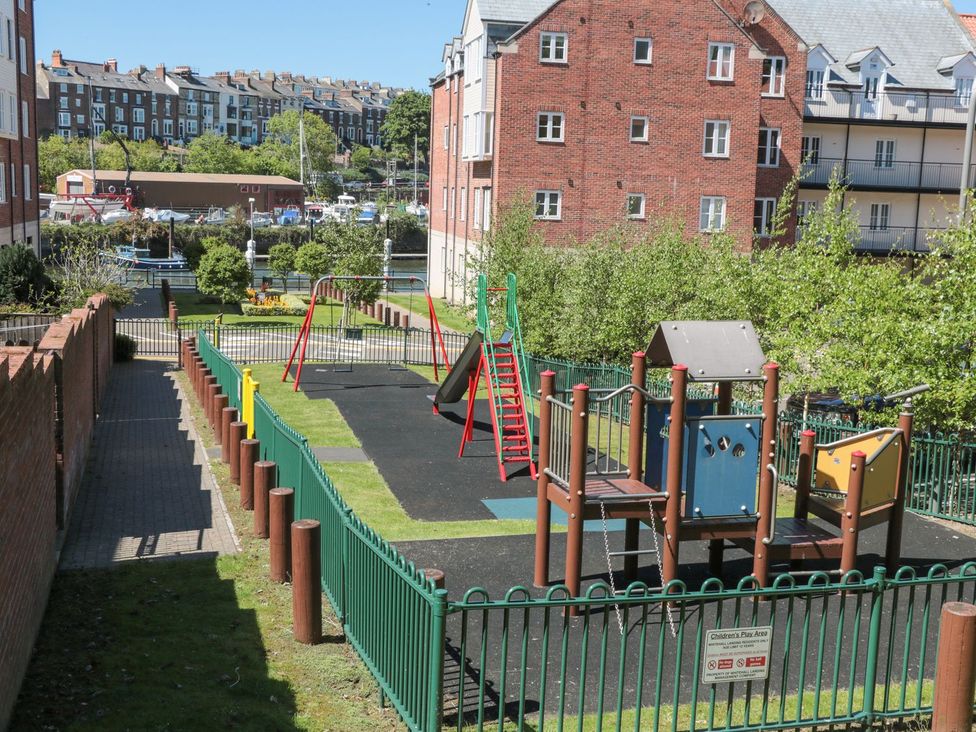 A playground with swings and climbing equipment at The Shipwrights in Whitby