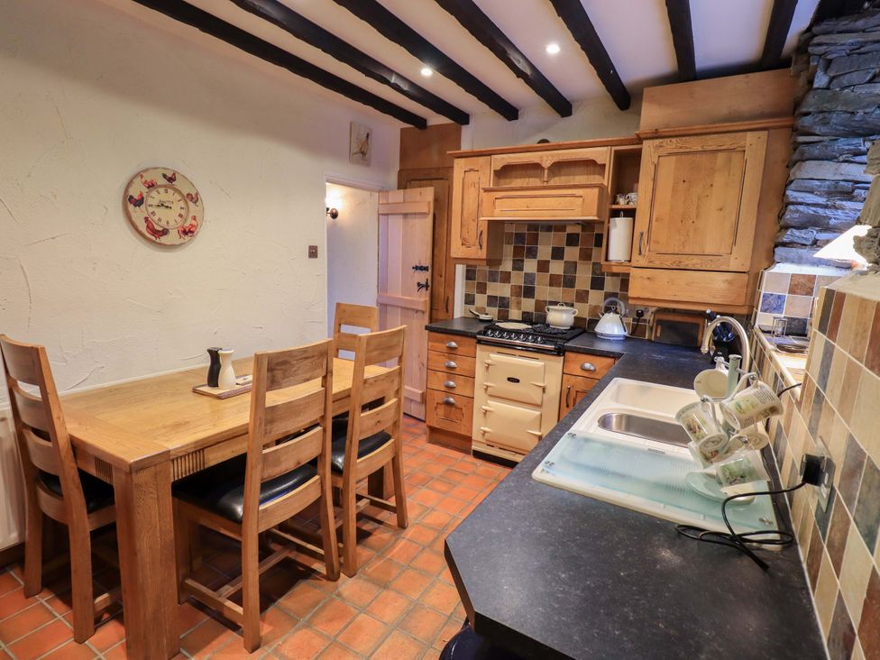 A kitchen with a table and chairs at Stoker’s Cottage in Windermere
