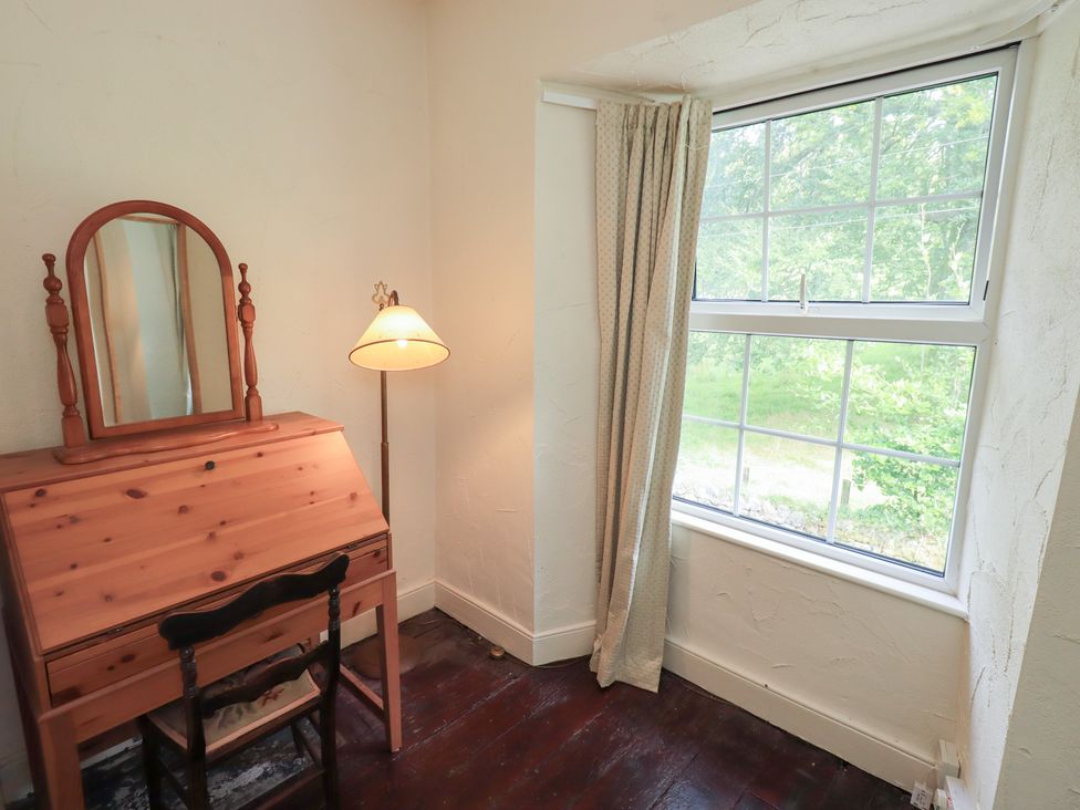 A bedroom with a desk and window at Stoker’s Cottage in Bowness-On-Windermere