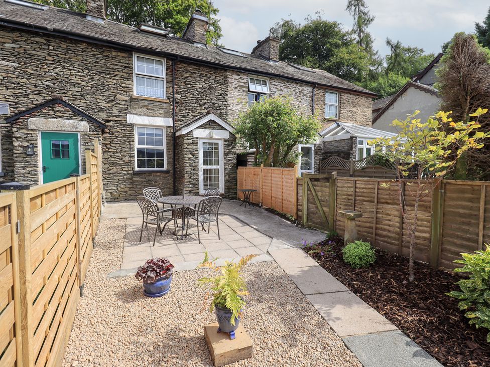An outdoor area with a patio and table at Stoker’s Cottage in Bowness-On-Windermere