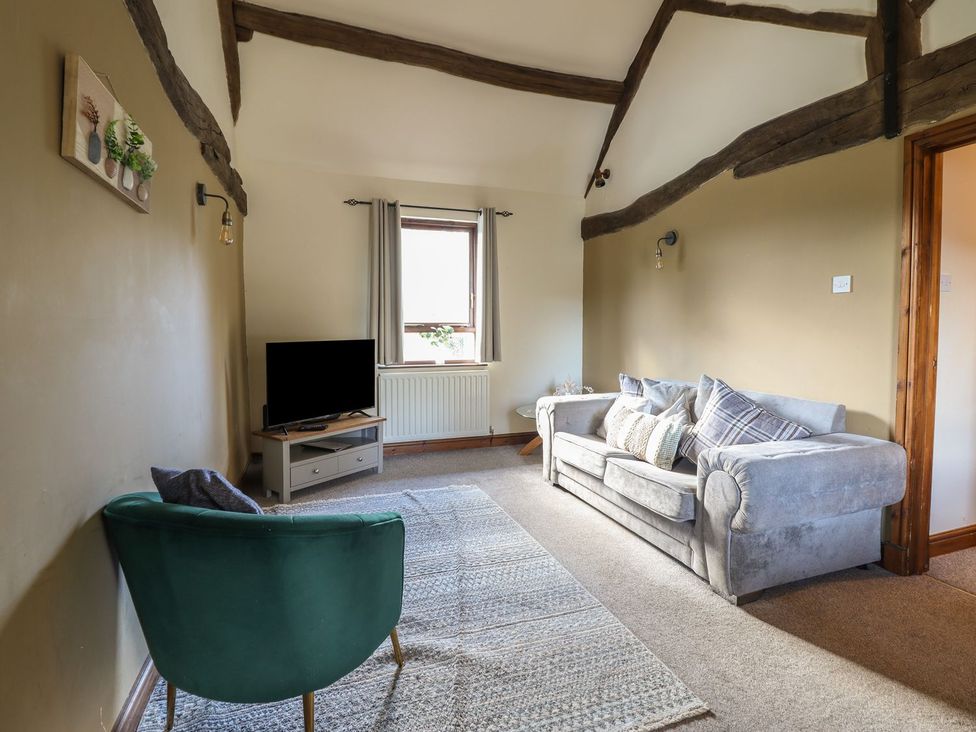 A living room with a sofa and television at Idris Barn Dolgellau