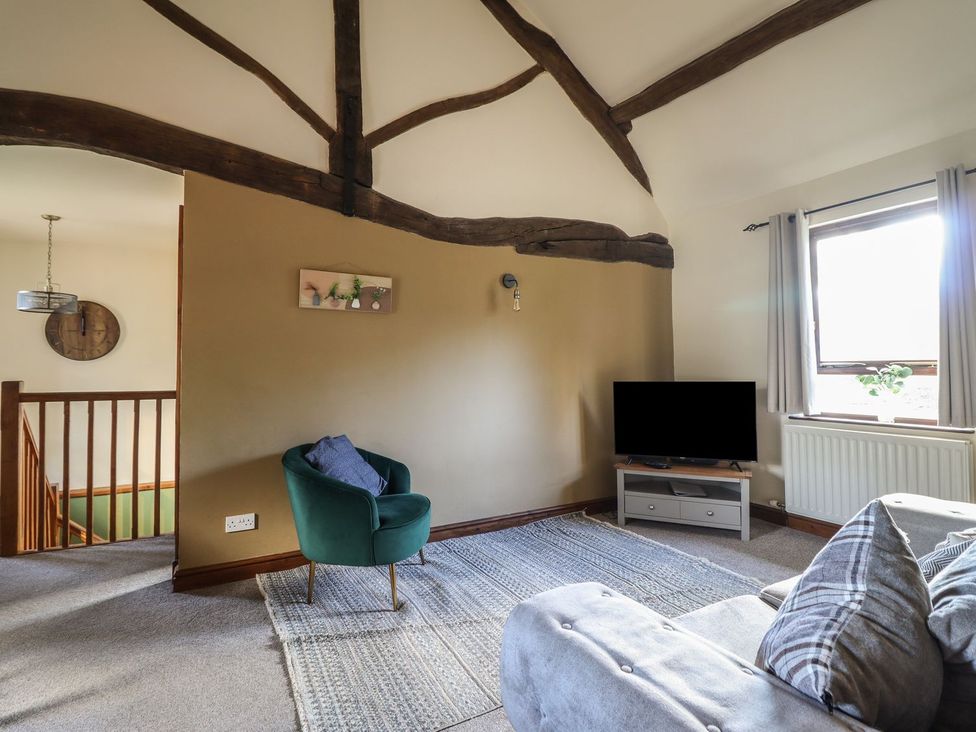 A living room with a sofa and television at Idris Barn in Dolgellau