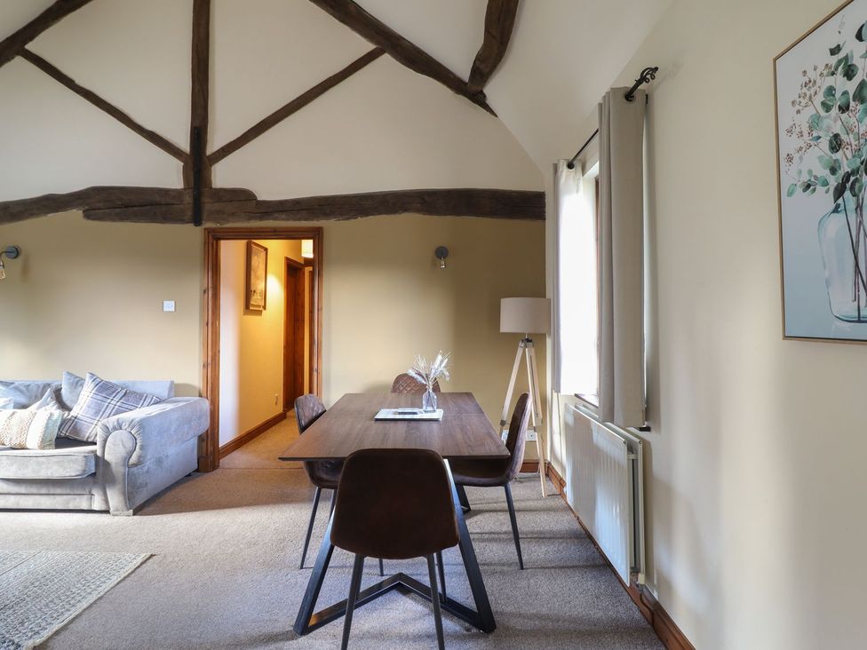 A living room with a sofa and dining area at Idris Barn in Dolgellau