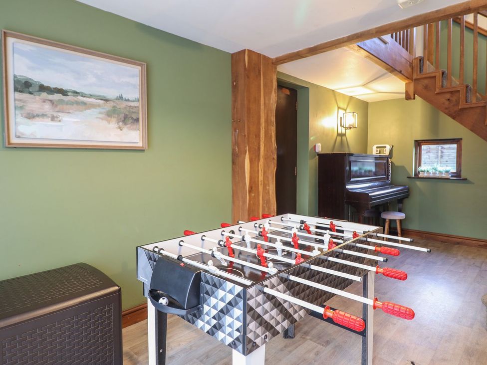 A games room with a foosball table and a piano at Idris Barn in Dolgellau
