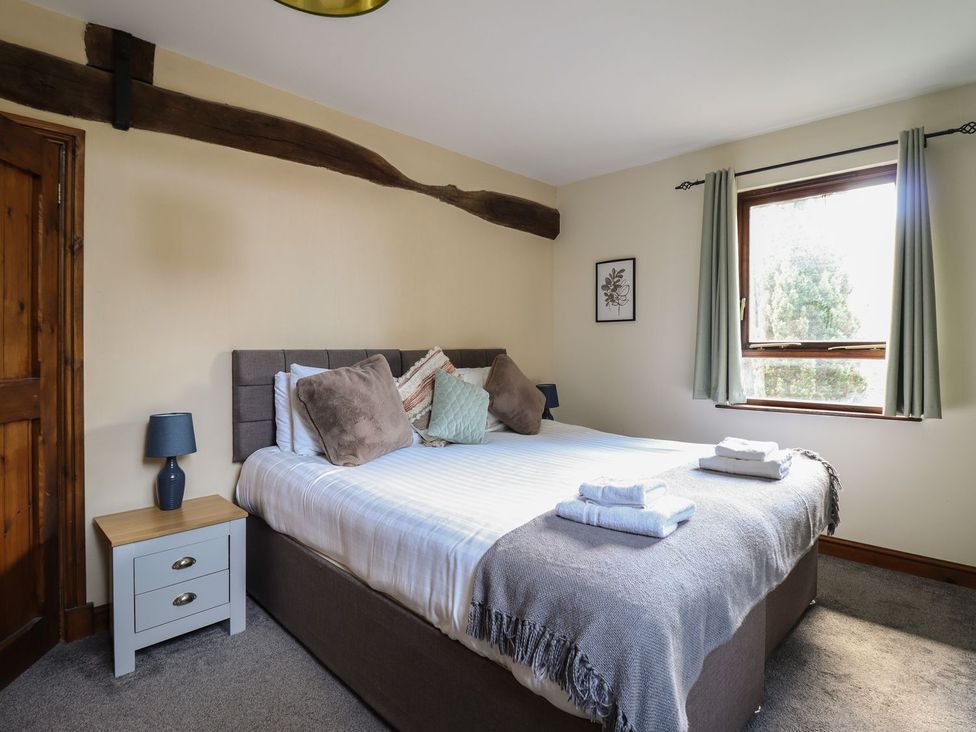 A bedroom with a bed and bedside table at Idris Barn Dolgellau