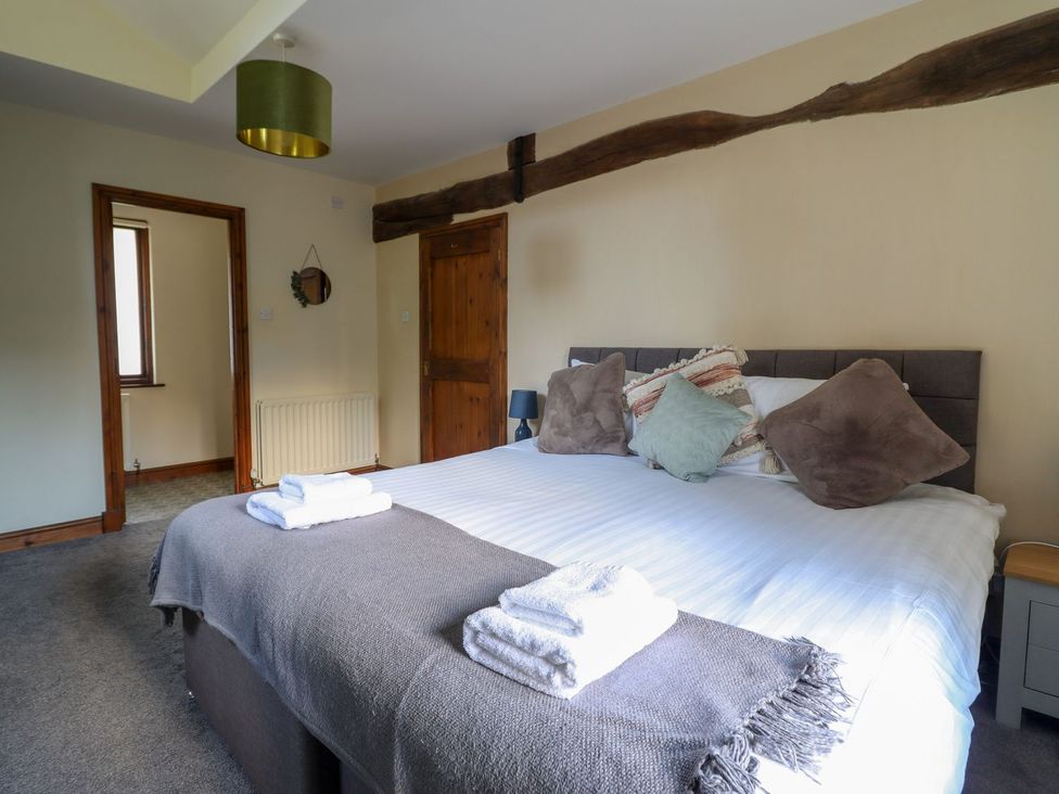 A bedroom with a bed and pillows at Idris Barn Dolgellau