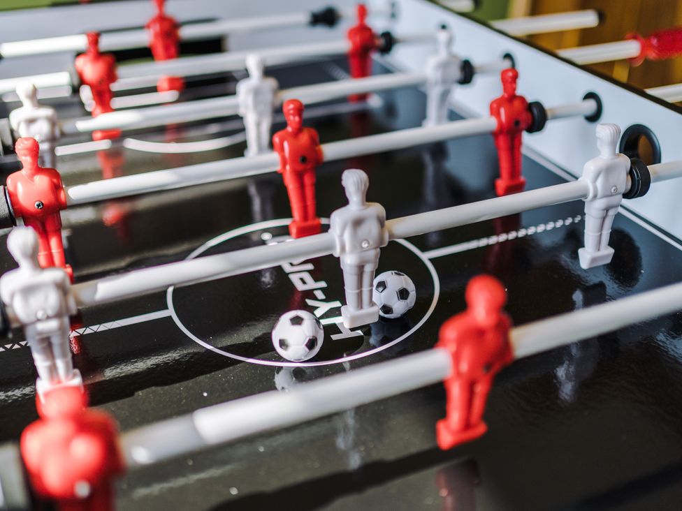 A foosball table with red and white players at Idris Barn Dolgellau