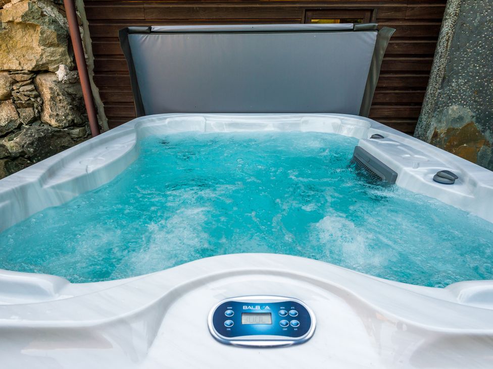 A hot tub with water and control panel at Idris Barn Dolgellau