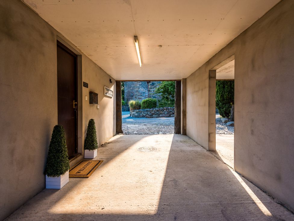 An entrance hall with a door and welcome mat at Idris Barn Dolgellau