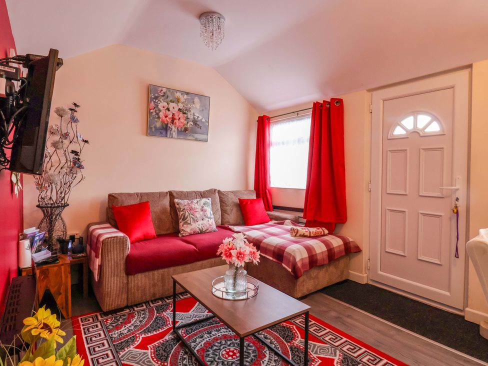 A living room with a sofa and table at Chalet 231 in Bridlington