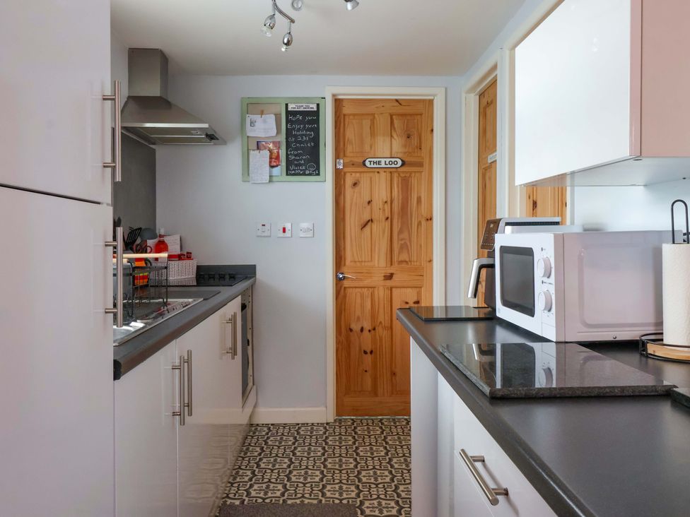 A kitchen with a microwave and sink at Chalet 231 in Bridlington