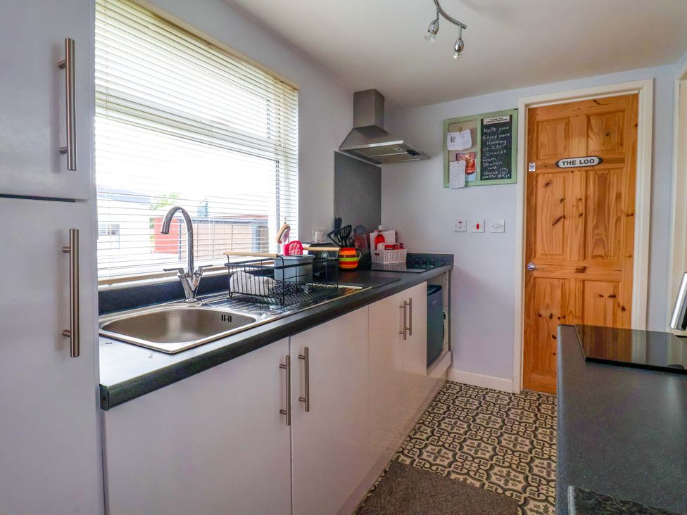 A kitchen with a sink and stove at Chalet 231 in Bridlington