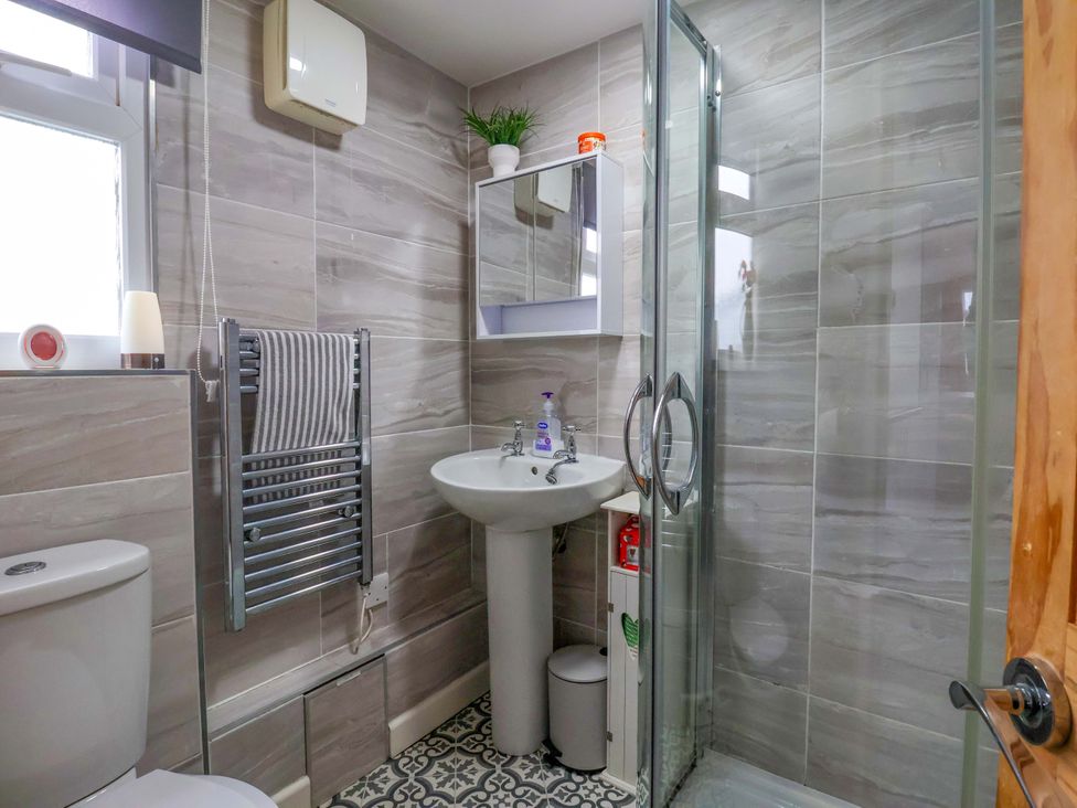 A bathroom with a sink and shower at Chalet 231 in Bridlington