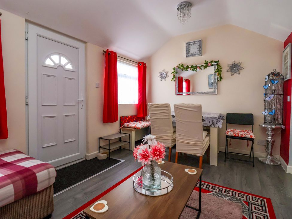 A living room with a dining area and front door at Sandbay in Bridlington