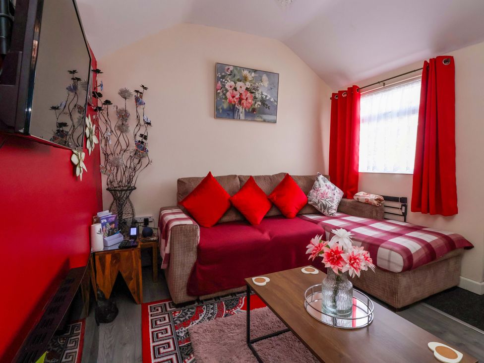 A living room with a sofa and coffee table at Sandbay in Bridlington