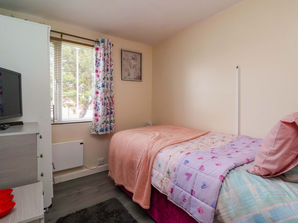 A bedroom with a bed and television at Sandbay in Bridlington