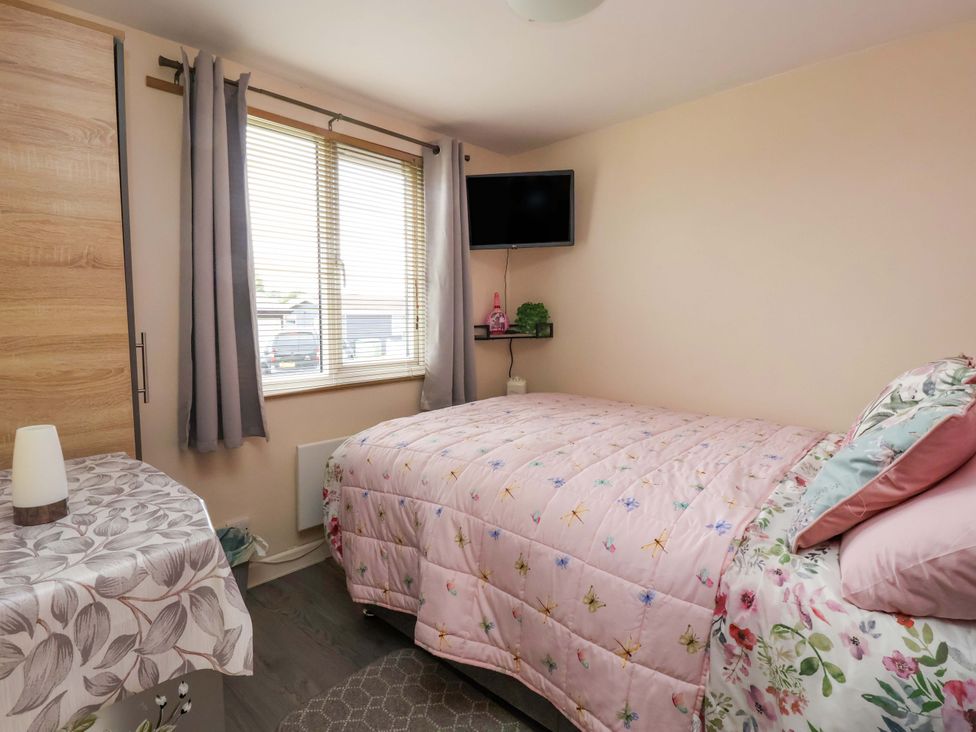 A bedroom with a bed and television at Sandbay in Bridlington