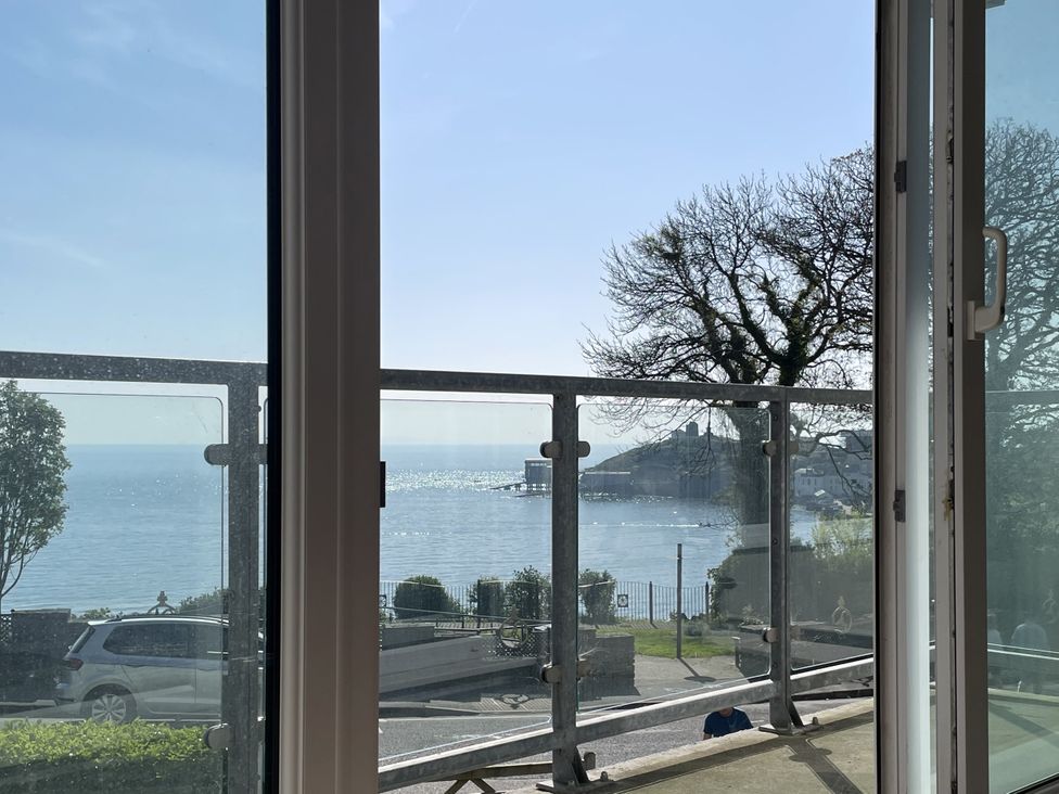 A view from a window showing a balcony overlooking the sea at 10 Croft Court in Tenby